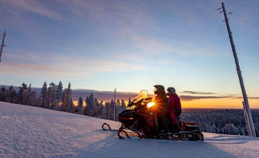 Levi: Twilight Snowmobile Safari & Stargazing Experience - Warming up in a Finnish wooden shelter